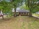 Charming brick home featuring a lush green lawn and mature trees at 5110 Old Well St, Durham, NC 27704