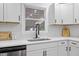 Bright kitchen features white cabinets, stainless appliances, undermount sink, and stylish backsplash at 5110 Old Well St, Durham, NC 27704