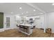 Modern kitchen with a large island, sleek countertops, and stainless steel appliances, perfect for cooking and entertaining at 5110 Old Well St, Durham, NC 27704