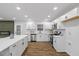 Modern kitchen with a large island, sleek countertops, and stainless steel appliances, perfect for cooking and entertaining at 5110 Old Well St, Durham, NC 27704