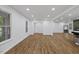 Open concept living room with modern flooring and recessed lighting, creating a bright and spacious atmosphere at 5110 Old Well St, Durham, NC 27704