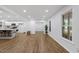 Open-concept living space featuring new flooring, paint, and modern lighting at 5110 Old Well St, Durham, NC 27704