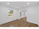 Bright living room featuring new windows and wood-look flooring, creating a modern and airy space at 5110 Old Well St, Durham, NC 27704