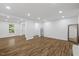 Bright living room with wood-look floors and neutral walls, a clean and inviting space for relaxation at 5110 Old Well St, Durham, NC 27704