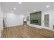 Cozy living room with a modern fireplace, wood-look flooring, and ample space for relaxation and entertaining at 5110 Old Well St, Durham, NC 27704
