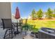 Backyard patio with table, umbrella, chairs, plants and view of grassy yard at 512 Barneswyck Dr, Fuquay Varina, NC 27526
