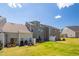Backyard view of townhomes with patios, seating, grill, and fenced yards at 512 Barneswyck Dr, Fuquay Varina, NC 27526