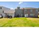 Backyard view of townhomes with patios, seating, grill, and fenced yards at 512 Barneswyck Dr, Fuquay Varina, NC 27526