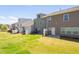 Backyard view of townhomes with patios, seating, grill, and fenced yards at 512 Barneswyck Dr, Fuquay Varina, NC 27526