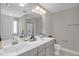 Modern bathroom with dual sinks, vanity, a large mirror, and a glass-enclosed shower at 512 Barneswyck Dr, Fuquay Varina, NC 27526