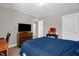 Cozy bedroom showcases a wood dresser, TV, and decorative items on a table near doorway at 512 Barneswyck Dr, Fuquay Varina, NC 27526