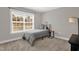 Neutrally decorated bedroom with window view, modern furniture, and cozy gray comforter at 512 Barneswyck Dr, Fuquay Varina, NC 27526