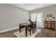 Cozy dining area with a table, three chairs, and a view of the outdoor patio at 512 Barneswyck Dr, Fuquay Varina, NC 27526