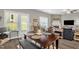 A cozy dining area with dark wood table, bench seating, and natural light from nearby windows at 512 Barneswyck Dr, Fuquay Varina, NC 27526