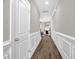 Inviting hallway featuring elegant trim, gleaming hardwood floors, and a glimpse into the cozy living area at 512 Barneswyck Dr, Fuquay Varina, NC 27526