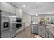 Modern kitchen featuring stainless steel appliances, granite countertops, and ample cabinet space at 512 Barneswyck Dr, Fuquay Varina, NC 27526