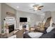 Relaxing living area with a cozy fireplace, TV, and stairs to the upper level at 512 Barneswyck Dr, Fuquay Varina, NC 27526