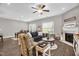 Cozy living room with a fireplace, ceiling fan, and neutral tones for a warm and inviting atmosphere at 512 Barneswyck Dr, Fuquay Varina, NC 27526