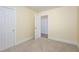 Bedroom features neutral carpet, base trim, and doorways at 605 E Montgomery St, Henderson, NC 27536