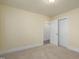 Bedroom features neutral carpet, base trim, and doorways at 605 E Montgomery St, Henderson, NC 27536