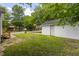 Wide shot of the detached garage, showing its placement in the backyard and proximity to neighboring homes at 605 E Montgomery St, Henderson, NC 27536