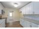 Bright kitchen featuring white cabinets, granite countertops and stainless steel appliances at 605 E Montgomery St, Henderson, NC 27536