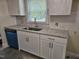 Kitchen featuring white cabinets, granite countertops, and a stainless steel sink at 605 E Montgomery St, Henderson, NC 27536