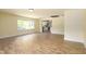 Open-concept living area with updated flooring, connecting seamlessly to the adjacent kitchen at 605 E Montgomery St, Henderson, NC 27536