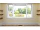 A Bright window in the living room with outside views, flooding the space with natural light at 605 E Montgomery St, Henderson, NC 27536
