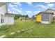 Large backyard featuring storage shed, patio, and a well-maintained lawn at 606 Arden St, Burlington, NC 27215