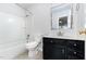Cozy bathroom featuring a shower-tub combo, vanity, and tiled floors at 606 Arden St, Burlington, NC 27215
