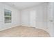Clean bedroom featuring a window letting in ample light and tile floors at 606 Arden St, Burlington, NC 27215