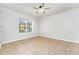Bright bedroom with tile flooring, a ceiling fan, and a large window offering a cozy retreat at 606 Arden St, Burlington, NC 27215