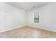Simple bedroom featuring a large window and tile floors at 606 Arden St, Burlington, NC 27215