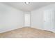Small bedroom with neutral walls, tile floors, and access to storage at 606 Arden St, Burlington, NC 27215