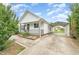 Well-kept home featuring a side carport and landscaped front yard for a blend of convenience and charm at 606 Arden St, Burlington, NC 27215