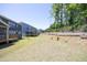 Home features a backyard, retaining wall, and deck that offers privacy and space for outdoor activities at 609 Ramsours Mill Dr, Holly Springs, NC 27540