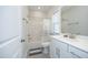 Bright bathroom featuring white cabinetry, neutral tile flooring and shower-tub combo at 609 Ramsours Mill Dr, Holly Springs, NC 27540
