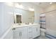 Bright bathroom featuring a double sink vanity with white cabinets, tiled floors, and a shower-tub combination at 609 Ramsours Mill Dr, Holly Springs, NC 27540