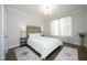 Bright bedroom featuring neutral décor, a queen bed, wood floors and decorative rugs at 609 Ramsours Mill Dr, Holly Springs, NC 27540