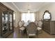 Elegant dining room featuring a large table, decorative chairs, and an ornate display cabinet at 609 Ramsours Mill Dr, Holly Springs, NC 27540