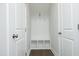 Hallway with a built-in bench, storage cubbies, and coat hooks, all in white at 609 Ramsours Mill Dr, Holly Springs, NC 27540