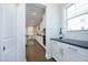 Well-lit kitchen with white cabinetry and stainless steel appliances at 609 Ramsours Mill Dr, Holly Springs, NC 27540
