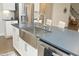 Modern kitchen island with stainless steel sink, faucet, dishwasher, and grey countertops at 609 Ramsours Mill Dr, Holly Springs, NC 27540