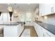 Modern kitchen with grey countertops, stainless steel appliances, and a central island at 609 Ramsours Mill Dr, Holly Springs, NC 27540
