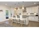 Open kitchen featuring a central island with seating, stainless steel appliances, and hardwood floors at 609 Ramsours Mill Dr, Holly Springs, NC 27540