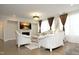 Bright living room showcasing elegant white furniture, a fireplace, and a large screen television at 609 Ramsours Mill Dr, Holly Springs, NC 27540