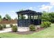 Community mailboxes under a pergola with manicured landscaping and shrubs at 609 Ramsours Mill Dr, Holly Springs, NC 27540