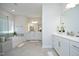 Bright main bathroom with double vanities, soaking tub, and glass-enclosed shower at 609 Ramsours Mill Dr, Holly Springs, NC 27540