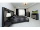 Stylish main bedroom with modern furnishings, neutral carpet, and a tray ceiling at 609 Ramsours Mill Dr, Holly Springs, NC 27540